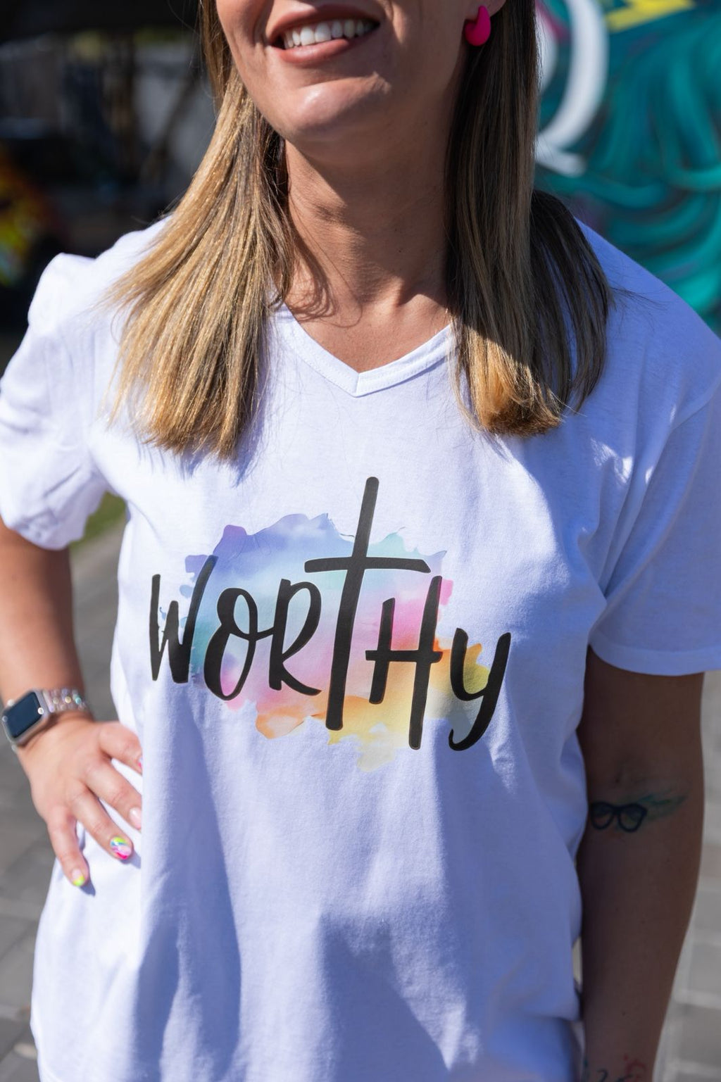 Faith in Fashion – Soft white ladies’ V-neck tees with a beautiful pastel watercolour splash background and bold faith declarations